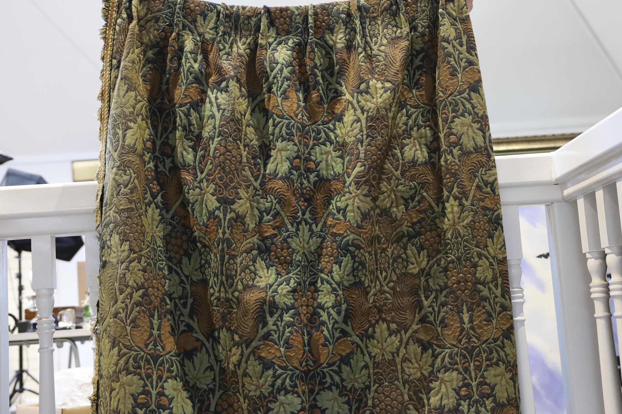 John Henry Dearle for Morris & Co. a pair of Squirrel design curtains, c.1890, hand loom woven wool at Merton Abbey, each with ornate braided edging and lining: 8ft 6ins. drop x 4ft wide each